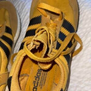 Yellow and black adidas trainers